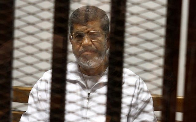 In this May 8, 2014 file photo, Egypt's ousted Islamist President Mohammed Morsi sits in a defendant cage in the Police Academy courthouse in Cairo, Egypt. (AP/Tarek el-Gabbas, File)