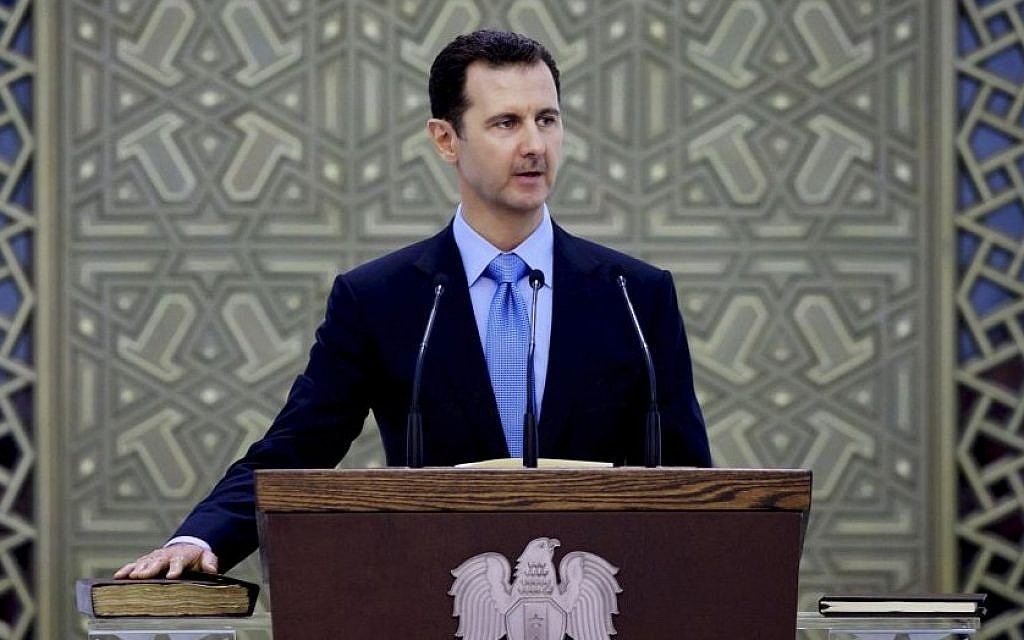 In this Wednesday, July 16, 2014 file photo released by the Syrian official news agency SANA, Syria's President Bashar Assad is sworn for his third, seven-year term, in Damascus, Syria (AP/SANA, File)