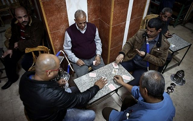 Egyptians play cards at a cafe in Cairo on November 24, 2014. (photo credit: AFP)