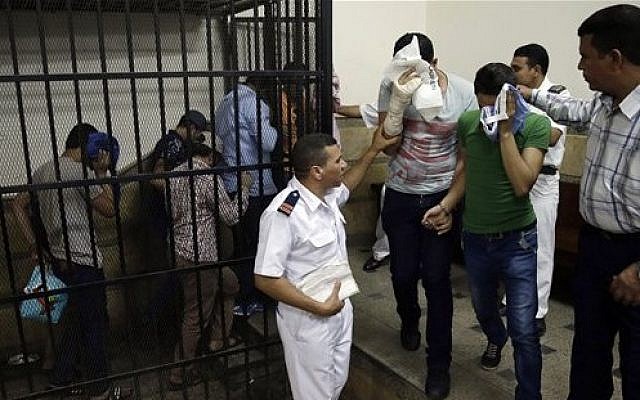 Illustrative: Eight Egyptian men convicted for 'inciting debauchery,' following their appearance in a video of an alleged same-sex wedding party on a Nile boat leave the defendant's cage in a courtroom in Cairo, Egypt, November 1, 2014. (AP/Hassan Ammar, File)