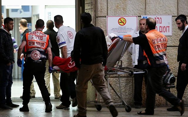 Paramedics bring victims injured in a stabbing attack to the Hadassah Ein Kerem hospital in Jerusalem on December 03, 2014. (photo credit: Noam Revkin Fenton/FLASH90)