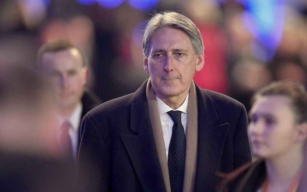 UK Defense Minister Philip Hammond (C) arrives at a tent build in front of the entrance of the former Nazi concentration camp Auschwitz-Birkenau for the main ceremony to mark the 70th anniversary of the liberation of the death camp on January 27, 2015 in Oswiecim, Poland. (photo Andersen: Odd Andersen/AFP)