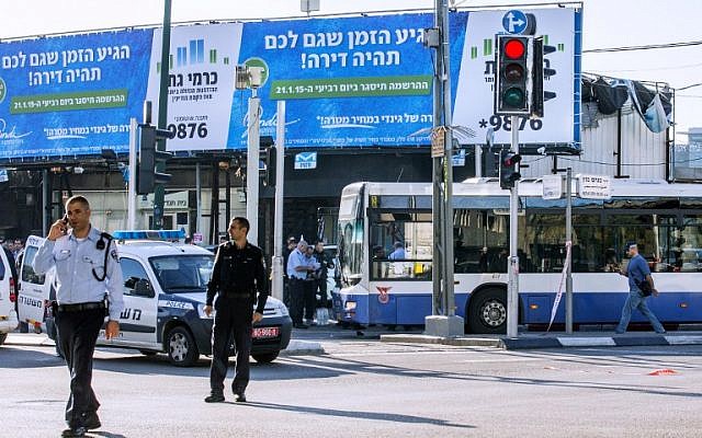 Israeli police officers stand at the scene of an attack on a Tel Aviv bus on January 21, 2015. (photo credit: AFP/JACK GUEZ)