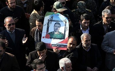 Iranian mourners carry a portrait of Brigadier General Mohammad Ali Allahdadi, a commander of the Islamic republic's Revolutionary Guards killed in a reported Israeli air strike on Syria, during his funeral procession in Tehran on January 21, 2015. (Photo credit: AFP/ATTA KENARE)