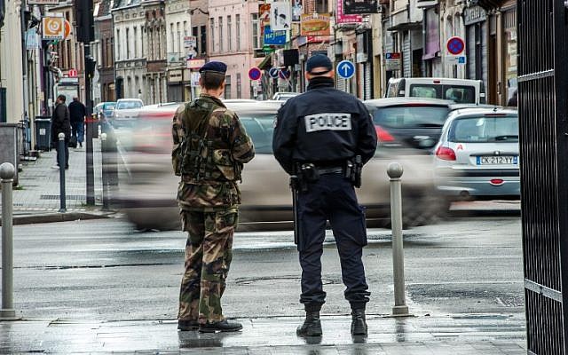 Illustrative photo of a French police officer and a soldier on patrol, January 13, 2015. (AFP/Philippe Huguen)