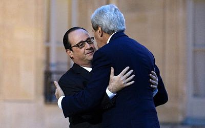 French President François Hollande welcomes US Secretary of State John Kerry prior,  January 16, 2015. (photo credit: AFP/Rick Wilking, Pool)