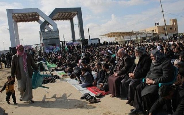 Palestinians gather in front of the Rafah border crossing point between southern the Gaza Strip and Egypt to protest against the closure of the border. Many Palestinians who travel through Rafah are students heading to universities in Egypt or beyond, or people in need of medical treatment, January 16, 2015. (Photo credit: AFP/SAID KHATIB)