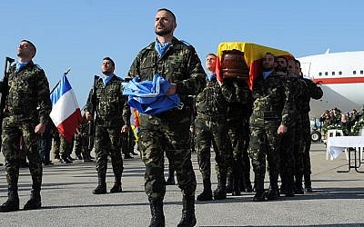 Honor guard carrying the flag-draped casket of departed Spanish peacekeeper, Lance Corporal Toledo, departs the memorial service held at the Beirut International Airport, on January 29, 2015. (photo credit: Courtesy UNIFIL)