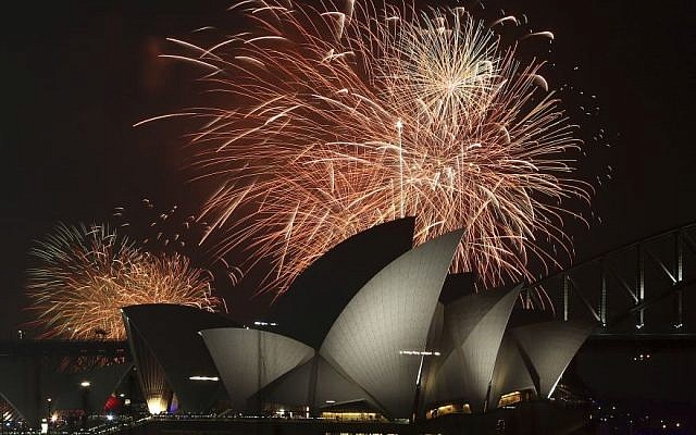 Illustrative: Fireworks explode over the Opera House and the Harbour Bridge during New Years Eve celebrations in Sydney, Australia, Wednesday, Dec. 31, 2014. (Photo credit: AP/Rob Griffith)