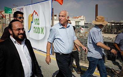 Uri Ariel touring a construction site in the settlement of Kokhav Yaakov, August 2013. (Flash90)