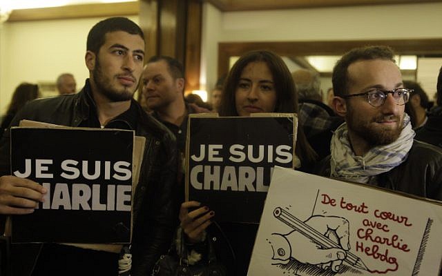 People hold signs that read 'Je suis Charlie' ('I am Charlie' at a solidarity rally at the French ambassador's residence in Jaffa, Israel, on January 8, 2015. (photo credit: Amir Levy/Flash90)
