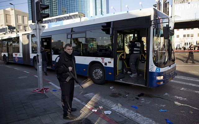 An Israeli police officer secures the scene after a stabbing attack in Tel Aviv on January 21, 2015. (photo credit: AP/Oded Balilty)
