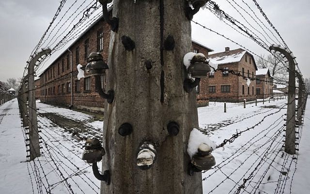 Barbed wire fences surround detention buildings at the Auschwitz Nazi death camp in Oswiecim, Poland, Monday, Jan. 26, 2015 (AP Photo/Alik Keplicz)