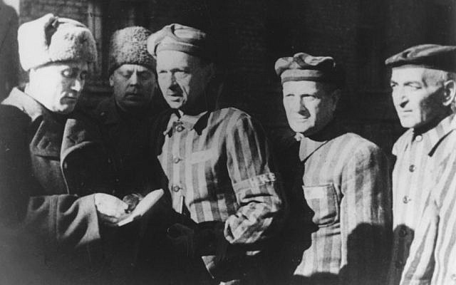 In this file photo dated January 1945, three Auschwitz prisoners, right, talk with Soviet soldiers after the Nazi concentration camp Auschwitz, in Poland, was liberated by the Russians. (Photo credit: AP/FILE)