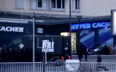 Hostages (bottom right) flee the Hyper Cacher supermarket as French security forces storm the building, January 9, 2014. (YouTube screenshot)
