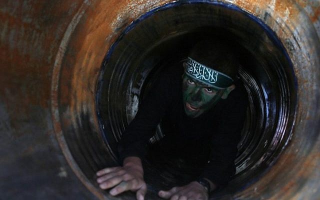 Illustrative: A Palestinian youth crawls in a tunnel during a graduation ceremony for a training camp run by the Hamas movement on January 29, 2015, in Khan Yunis, in the southern Gaza Strip. (AFP photo/Said Khatib)