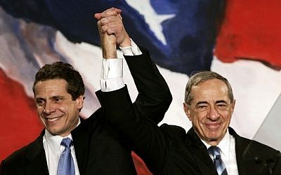In this November 7, 2006 file photo, then New York Attorney General Elect Andrew Cuomo (L) joins hands with his father, former New York Governor Mario Cuomo, during a rally held by New York Democrats.  (photo credit: AFP PHOTO / Files / Timothy A. Clary)