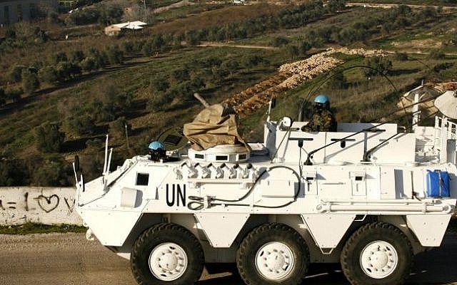 A Spanish UNIFIL peacekeeper drives an armored vehicle in the Lebanese town of Adaisseh, near the border with Israel, on January 19, 2015. (AFP/Mahmoud Zayyat)