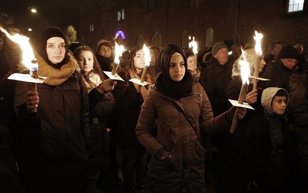 People hold candles during a memorial service for those killed by a gunman in Copenhagen, February 16, 2015 (Photo credit: Bax Lindhardt/Scanpix Denmark/AFP)