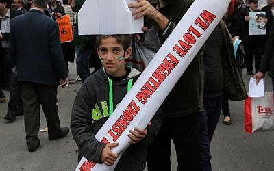 Iranians hold mock missiles bearing anti-Israel slogans during a rally in Tehran's Azadi Square (Freedom Square) to mark the 36th anniversary of the Islamic revolution on February 11, 2015. (photo credit: AFP PHOTO / ATTA KENARE)