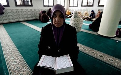 Fatma Zohra, one of the female religious guides known as Mourshidates and appointed by the Algerian religious affairs ministry, reads the Koran at the Ennidal mosque in the Algerian capital, Algiers, on February 22, 2015. (Photo credit: AFP/ FAROUK BATICHE)