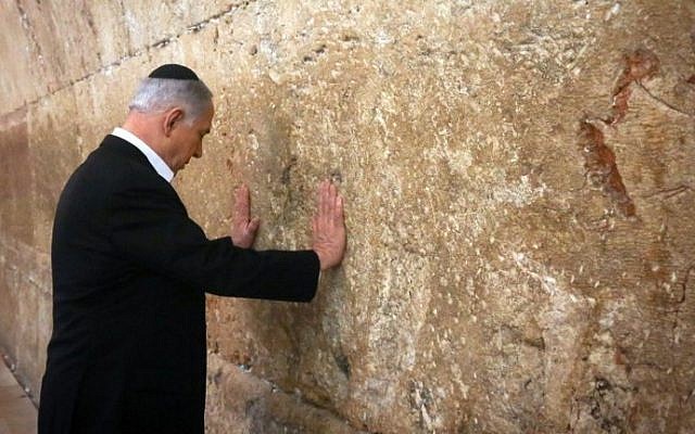 Prime Minister Benjamin Netanyahu prays at the Western Wall in the Old City of Jerusalem on February 28, 2015 (Photo credit: AFP/Pool/Marc Sellem)