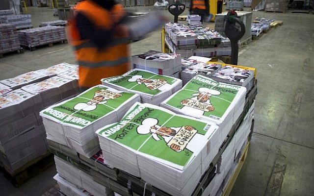 Illustrative: Employees checking the arrival of the then forthcoming edition of the weekly satirical newspaper Charlie Hebdo, on January 13, 2015, Paris, France. (AFP/Martin Bureau)