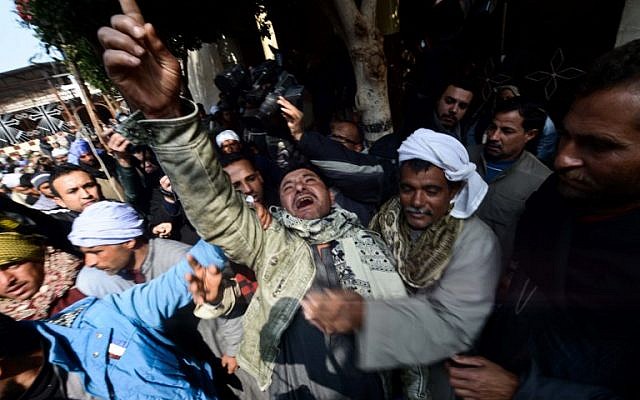 A relative of one of the Egyptian Coptic Christians purportedly murdered by Islamic State (IS) group militants in Libya reacts after hearing the news on February 16, 2015 in the village of Al-Awar in Egypt's southern province of Minya. (photo credit: AFP photo/Mohamed El-Shahed)