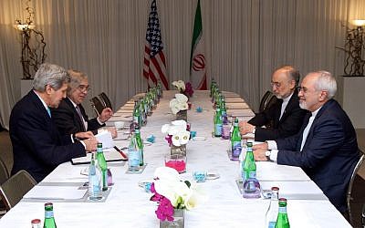 Secretary of State John Kerry and US Energy Secretary Ernest Moniz sit across from Iranian Foreign Minister Javad Zarif and Ali Akbar Salehi on February 22, 2015, in Geneva, Switzerland, before a four-way discussion about the future of Iran's nuclear program. (photo credit: US State Department)