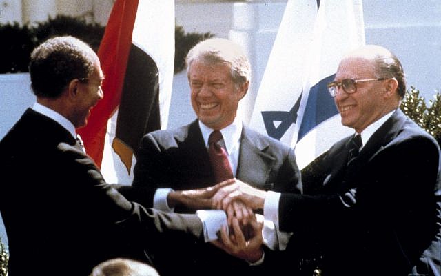 Egyptian president Anwar Sadat, US president Jimmy Carter, center, and Israeli prime minister Menachem Begin clasp hands on the north lawn of the White House as they sign the peace treaty between Egypt and Israel, March 26, 1979. (AP/Bob Daugherty)