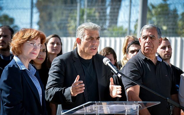 Yair Lapid with Yesh Atid members Yael German and Miki Levy announced a new legislation plan to fight corruption in Israeli politics outside the Ma'asiyahu Prison in Ramle, on February 2, 2015. (Flash90)