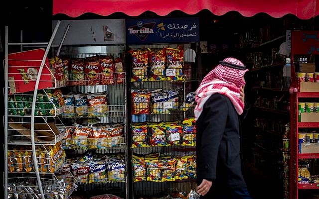 A Palestinian man walks by a store that stacks Israeli snacks in Bethlehem, on February 11, 2015. (photo credit: Miriam Alster/Flash 90)