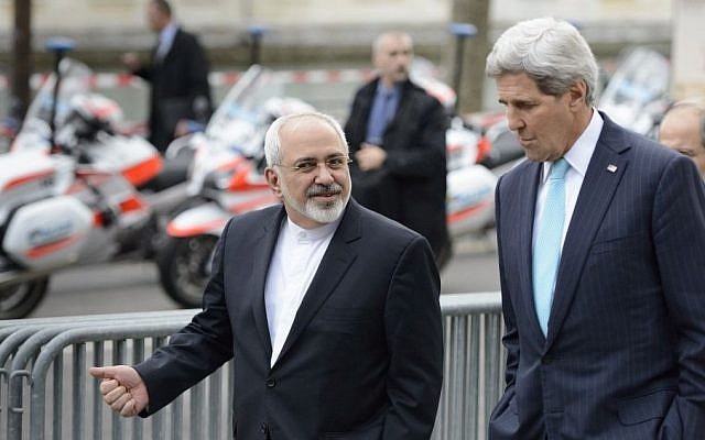 US Secretary of State John Kerry (right), speaks with Iranian Foreign Minister Mohammad Javad Zarif as they walk in Geneva, Switzerland, ahead of nuclear discussions, January 14, 2015. (AP/Keystone, Laurent Gillieron, File)