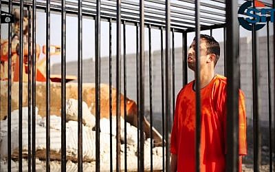This still image made from video released by Islamic State group militants and posted on the website of the SITE Intelligence Group on Tuesday, Feb. 3, 2015, purportedly shows Jordanian pilot Lt. Muath al-Kaseasbeh standing in a cage just before being burned to death by his captors. The death of the 26-year-old pilot, who fell into the hands of the militants in December when his Jordanian F-16 crashed near Raqqa, Syria, followed a weeklong drama over a possible prisoner exchange. (photo credit: AP Photo/SITE Intelligence Group)