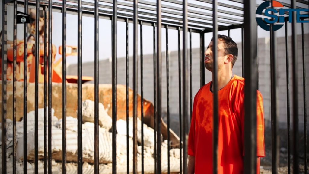 This still image made from a video released by Islamic State group militants and posted on the website of the SITE Intelligence Group on February 3, 2015, purportedly shows Jordanian pilot Lt. Mu'ath al-Kaseasbeh standing in a cage just before being burned to death by his captors. (photo credit: AP/SITE Intelligence Group)