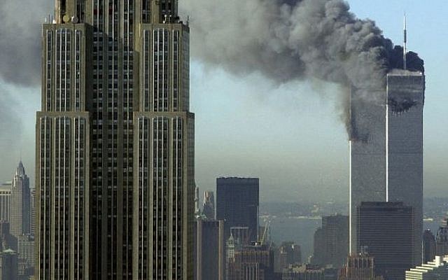 In this Tuesday, Sept. 11, 2001 file photo, plumes of smoke rise from the World Trade Center buildings in New York. The Empire State building is seen in the foreground. (photo credit: AP Photo/Patrick Sison, File)