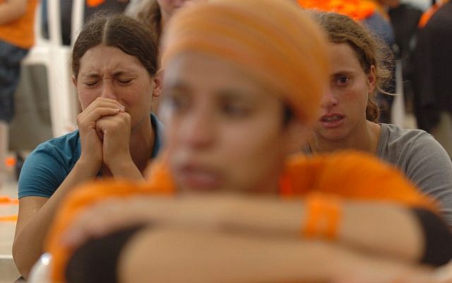 Settlers cry and pray during the disengagement from Gush Katif on August 18, 2005 (photo credit: Nati Shohat/Flash90)