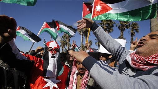 Jordanians chant slogans to show their support for the government against terror as they were waiting for Jordan's King Abdullah II, returning from the US, at Queen Alia Airport in Amman, Jordan, Wednesday, Feb. 4, 2015. (AP Photo/Raad Adayleh)