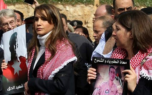 Jordan's Queen Rania holds a picture of slain Jordanian pilot, Lt. Muath al-Kaseasbeh, during a march after Friday prayers in Amman, Jordan, Friday, Feb. 6, 2015 (photo credit: AP/Raad Adayleh)