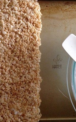 Spread the Rice Krispie mixture into a big block before cutting into triangles (Rebecca Pliner/JTA)