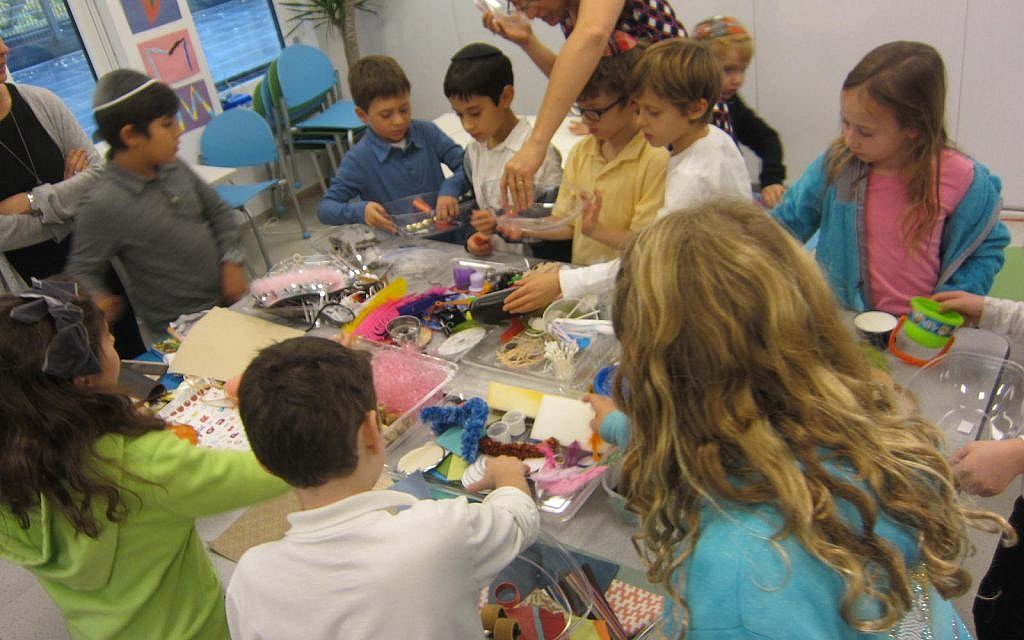 Shefa students working on an art project in which they make self-portrait collages. (The Shefa School/via JTA)