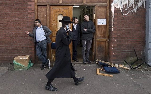 Illustrative photo of an Orthodox Jew walking past the Ahavas Torah Synagogue in the Stamford Hill area of north London on March 22, 2015. (AFP/Niklas Halle'n)