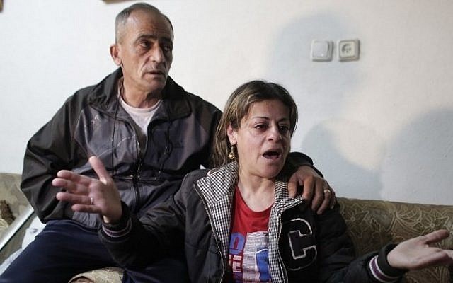 The parents of Arab-Israeli Muhammad Musallam react at the family's home in the Beit Hanina neighborhood of East Jerusalem on March 10, 2015, after the Islamic State (IS) released a video purportedly showing a young boy executing their son. (photo credit: AFP / AHMAD GHARABLI)