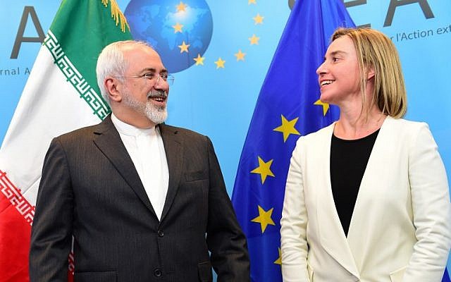 Iranian Foreign Minister Mohammad Javad Zarif, left, is welcomed by EU foreign policy chief Federica Mogherini on March 16, 2015 at the European External Action service headquarters in Brussels.(photo credit: AFP/ EMMANUEL DUNAND)