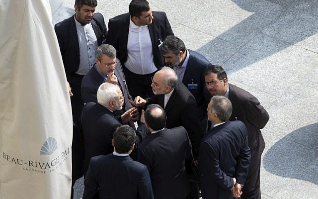 Iran's Foreign Minister Mohammad Javad Zarif (C on left) and head of the Atomic Energy Organization of Iran Ali Akbar Salehi (C on right) talk outside with aides after a morning negotiation session with U.S. Secretary of State John Kerry over Iran's nuclear program in Lausanne March 19, 2015. (photo credit: AFP/ POOL / Brian Snyder)