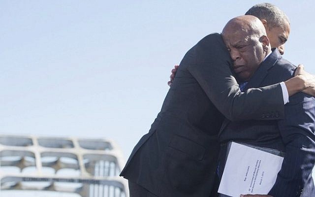 US President Barack Obama, right, hugs US Representative John Lewis,  one of the original marchers at Selma, during an event marking the 50th Anniversary of the Selma to Montgomery civil rights marches at the Edmund Pettus Bridge in Selma, Alabama, March 7, 2015. (AFP PHOTO / SAUL LOEB)