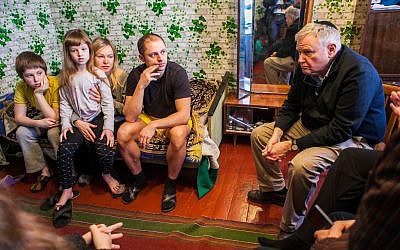 Head of Boston's Combined Jewish Philanthropies Barry Shrage (far right) with a family of Internally Displaced Persons in Dnepropetrovsk, Ukraine during a March trip there. (Courtesy CJP)