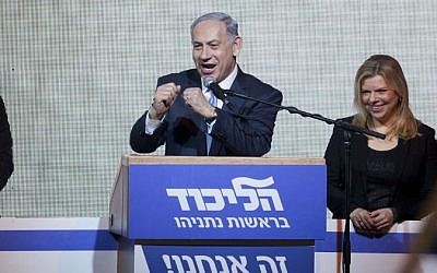 A victorious Prime Minister Benjamin Netanyahu greets supporters at the party's election headquarters In Tel Aviv. early on Wednesday, March 18, 2015. (photo credit: AP Photo/Dan Balilty)