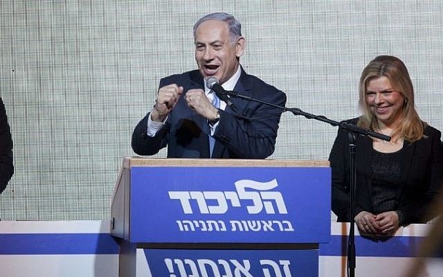 A victorious Prime Minister Benjamin Netanyahu greets supporters at the party's election headquarters In Tel Aviv. early on Wednesday, March 18, 2015. (photo credit: AP Photo/Dan Balilty)