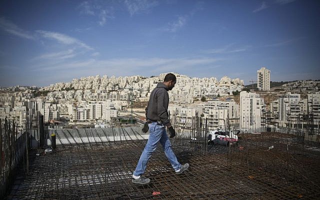 A construction worker next to the East Jerusalem neighborhood of Har Homa in October, 2014. (Hadas Parush/Flash90)